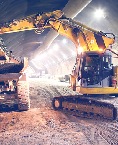 loading soil into dump truck in a tunnel