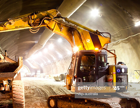 loading soil into dump truck in a tunnel